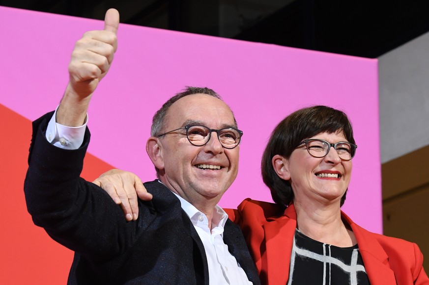Norbert Walter-Borjans, left, and Saskia Esken celebrate after winning the member voting of the Social Democratic Party, SPD, chairmanship at the party&#039;s headquarters in Berlin, Germany, Saturday ...