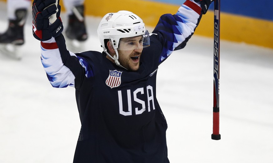 Garrett Roe (11), of the United States, celebrates after scoring a goal against Slovakia during the third period of the qualification round of the men&#039;s hockey game at the 2018 Winter Olympics in ...