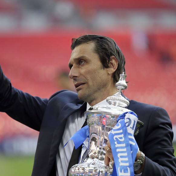 Chelsea head coach Antonio Conte holds the trophy after winning the English FA Cup final soccer match between Chelsea and Manchester United at Wembley stadium in London, Saturday, May 19, 2018. Chelse ...