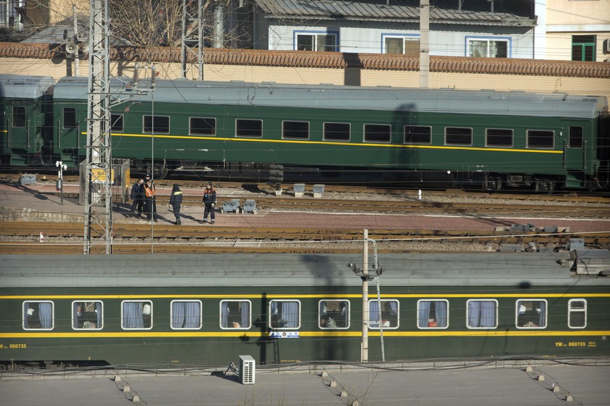 A train similar to one seen during previous visits by North Korean leader Kim Jong Un, at rear, passes by a Chinese passenger train as it arrives at Beijing Railway Station in Beijing, Tuesday, Jan. 8 ...