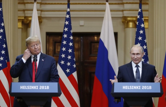U.S. President Donald Trump, left, and Russian President Vladimir Putin arrive for a press conference after the meeting of U.S. President Donald Trump and Russian President Vladimir Putin at the Presi ...
