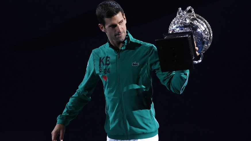 Serbia&#039;s Novak Djokovic carries the Norman Brookes Challenge Cup around Rod Laver Arena after defeating Austria&#039;s Dominic Thiem in the men&#039;s singles final of the Australian Open tennis  ...
