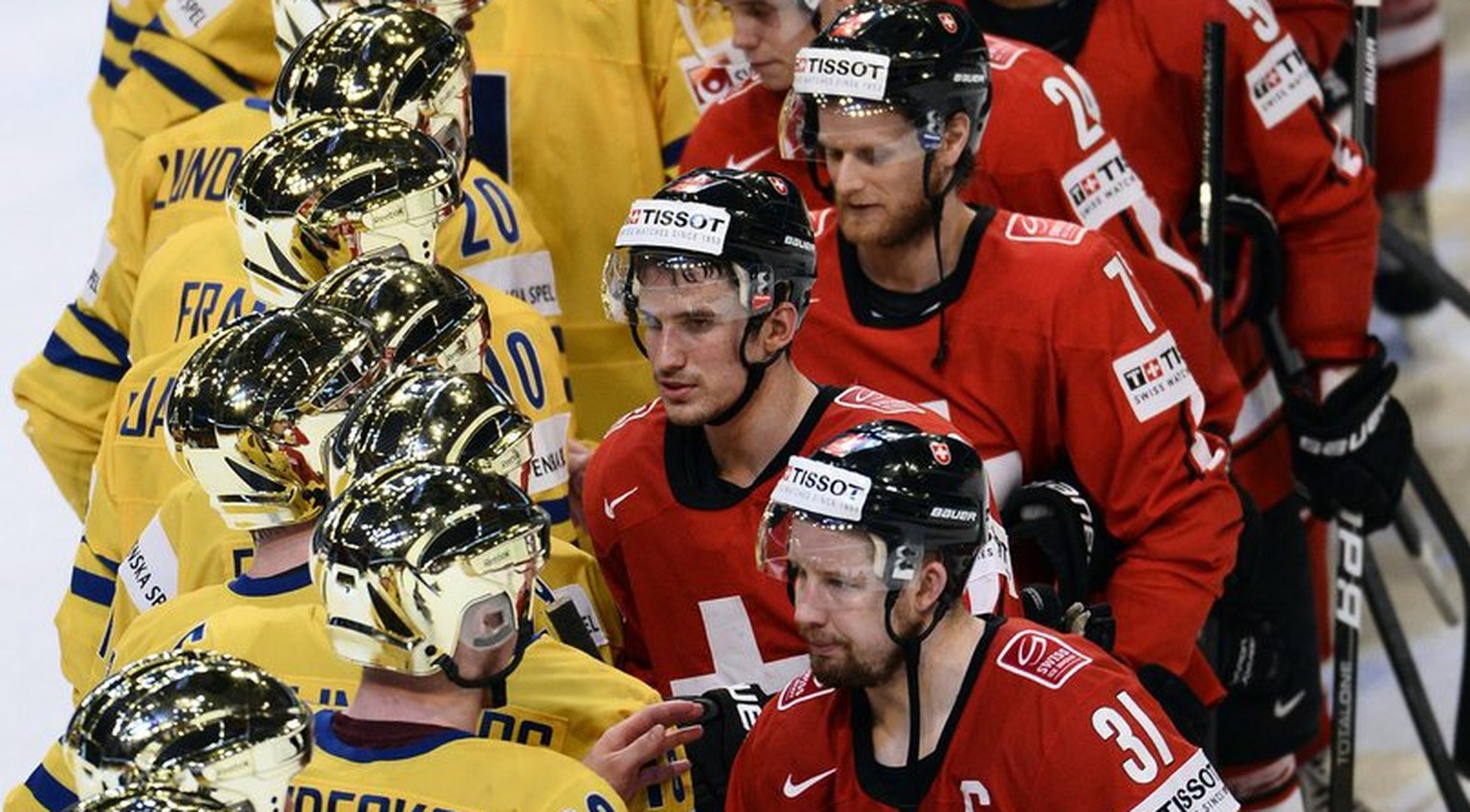 epa03708304 Swedish players, (L) shake hands with Swiss players after Sweden won the 2013 Ice Hockey IIHF World Championships final match between Switzerland and Sweden at the Ericsson Globe Arena in  ...