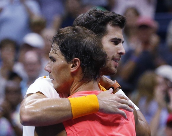 Rafael Nadal, of Spain, hugs Karen Khachanov, of Russia, after Nadal defeated Khachanov during the third round of the U.S. Open tennis tournament, Friday, Aug. 31, 2018, in New York. (AP Photo/Jason D ...