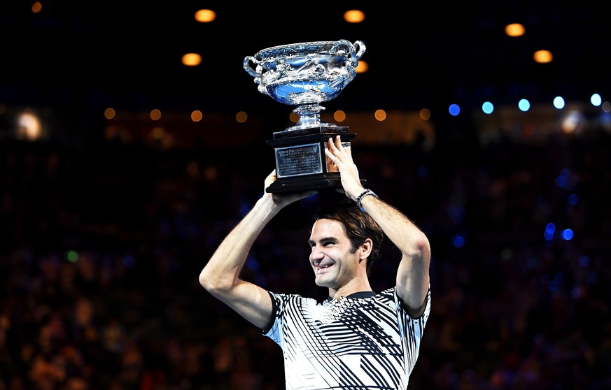 epaselect epa05759083 Roger Federer of Switzerland celebrates with the trophy after winning the Men&#039;s Singles final match against Rafael Nadal of Spain at the Australian Open Grand Slam tennis to ...