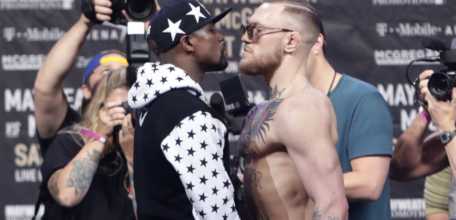 In this July 13, 2017, file photo, Floyd Mayweather Jr., left, and Conor McGregor, of Ireland, face each other for photos during a news conference at Barclays Center in New York. Nevada boxing regulat ...