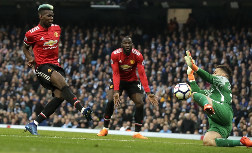 Manchester United&#039;s Paul Pogba scores his side&#039;s first goal past Manchester City goalkeeper Ederson, right, during the English Premier League soccer match between Manchester City and Manches ...