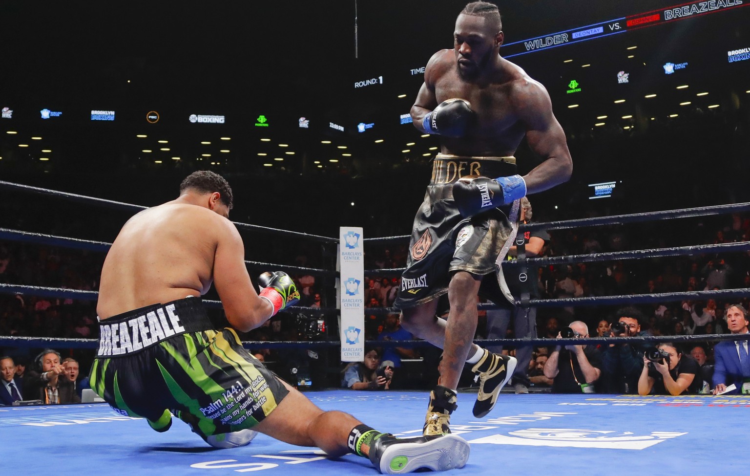 Deontay Wilder, left, knocks down Dominic Breazeale during the first round of the WBC heavyweight championship boxing match Saturday, May 18, 2019, in New York. Wilder won in the first round. (AP Phot ...