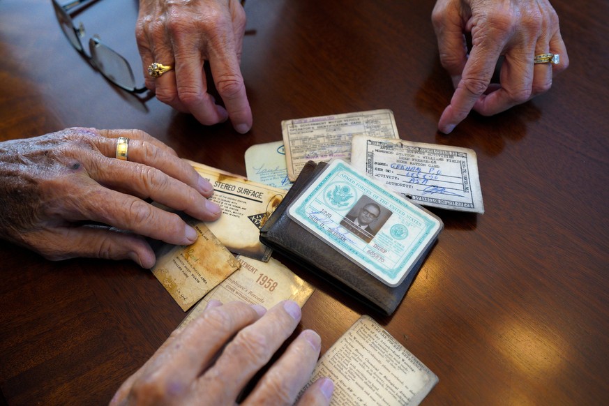 Paul Grisham and his wife Carole Salazar look over his wallet and the items that were inside when he lost it in Antarctica back in 1968 at their home in the San Carlos neighborhood of San Diego, Calif ...