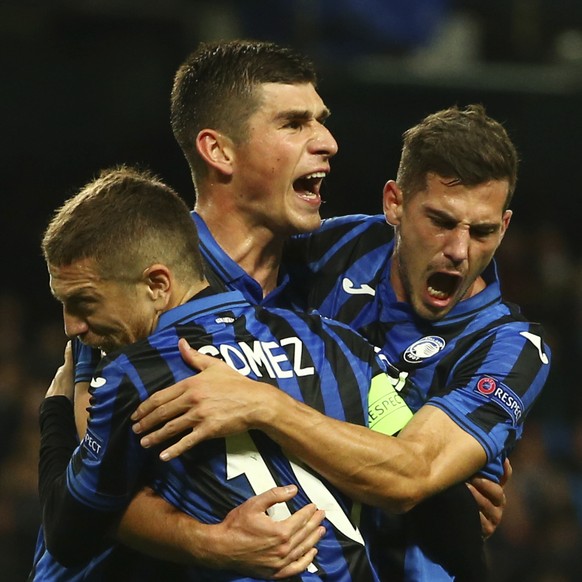 Atalanta&#039;s Ruslan Malinovskyi, center, celebrates with his teammates Papu Gomez, left, Remo Freuler after scoring on a penalty kick his side&#039;s first goal, during the group C Champions League ...