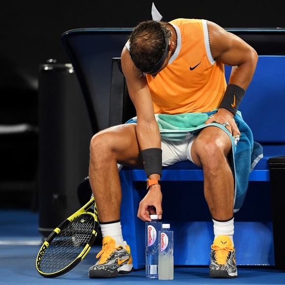 epa07296090 Rafael Nadal of Spain arranges his water bottles during a break in his men&#039;s singles third round match against Alex de Minaur of Australia at the Australian Open Grand Slam tennis tou ...