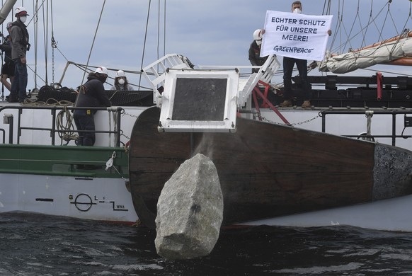 Greenpeace activists sink large blocks of granite into the Baltic Sea off the island of Ruegen near Sassnitz, Germany, Sunday, July 26, 2020. With the action in the Adlergrund Marine Reserve, the envi ...