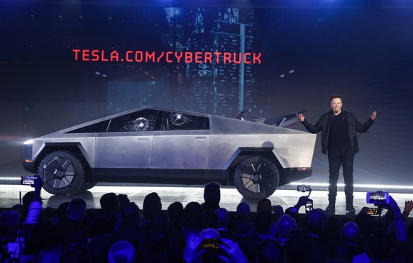 FILE - In this Nov. 21, 2019 file photo, Tesla CEO Elon Musk introduces the Cybertruck at Tesla&#039;s design studio in Hawthorne, Calif. The much-hyped unveil of TeslaÄôs electric pickup truck went  ...