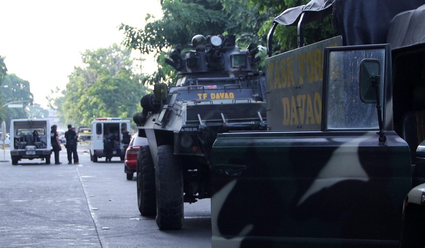 epa05521336 A military tank and trucks parked near the site of an explosion at a night market in Davao city, Philippines, 03 September 2016. Fourteen people were killed and 67 others wounded in an exp ...