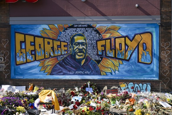 epa08473930 People continue to bring flowers and lay them at the mural near the intersection of 38th and Chicago where two weeks ago George Floyd was arrested and later died in police custody, in Minn ...