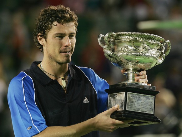 MELBOURNE, AUSTRALIA - JANUARY 30: Marat Safin of Russia holds the trophy aloft after winning the Men&#039;s Final against Lleyton Hewitt of Australia during day fourteen of the Australian Open Grand  ...