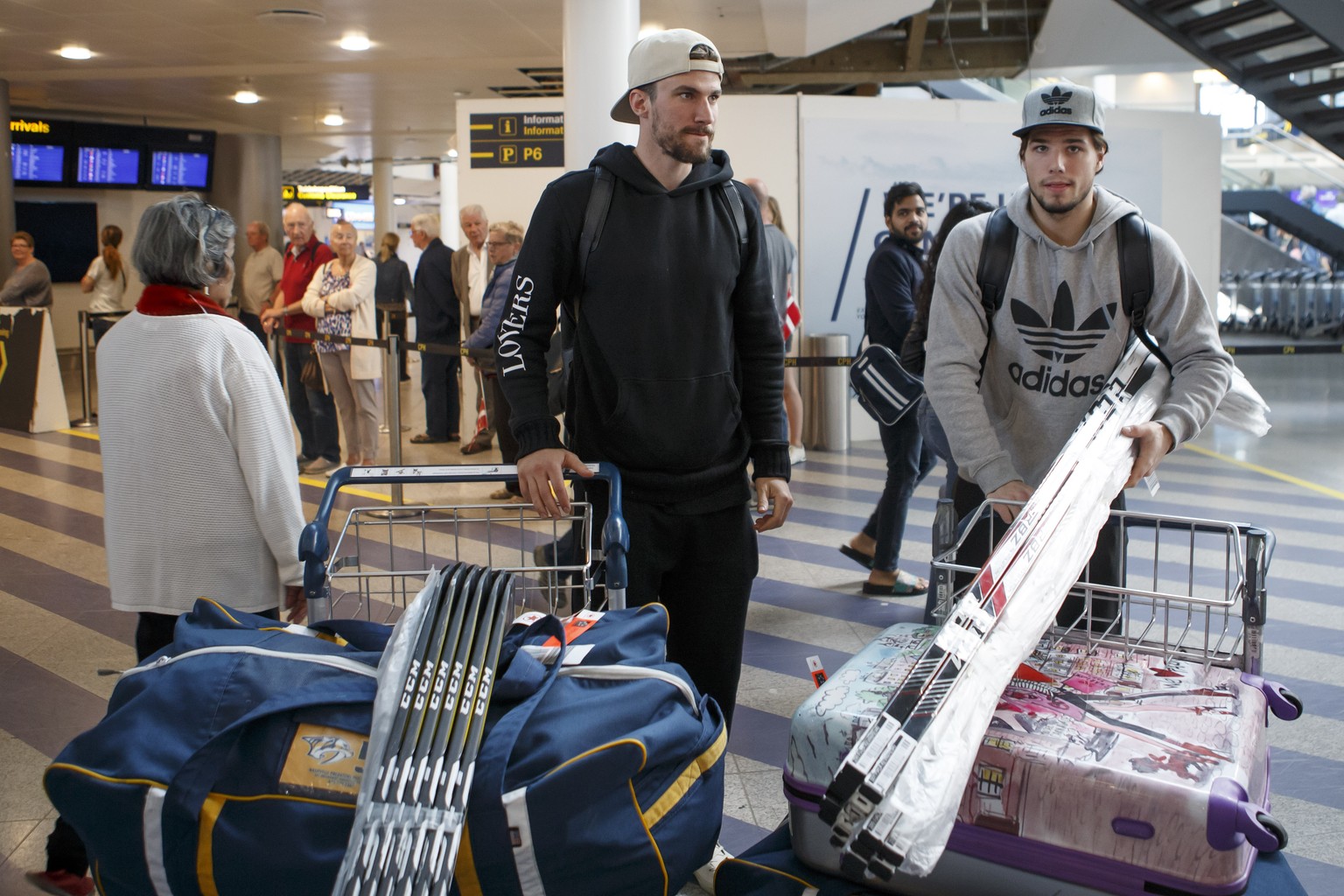 Switzerland&#039;s players defender Roman Josi, left, and forward Kevin Fiala, right, arrive to airport for take part to the IIHF 2018 World Championship, in Copenhagen, Denmark, Sunday, May 13, 2018. ...