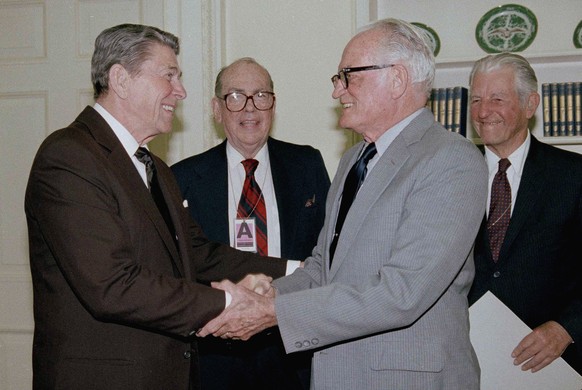 President Ronald Reagan congratulates Sen. Barry Goldwater (R-Ariz.), who received the Harmon Trophy at the White House in Washington, May 29, 1986, for his lifetime support of aviation and achievemen ...