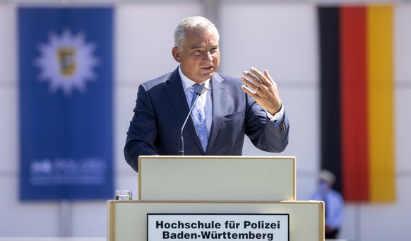 epa08572661 Minister of the Interior, Digitisation and Migration for Baden-Wuerttemberg state Thomas Strobl speaks during the swearing-in ceremony for Police academy graduates in Biberach, Germany, 29 ...