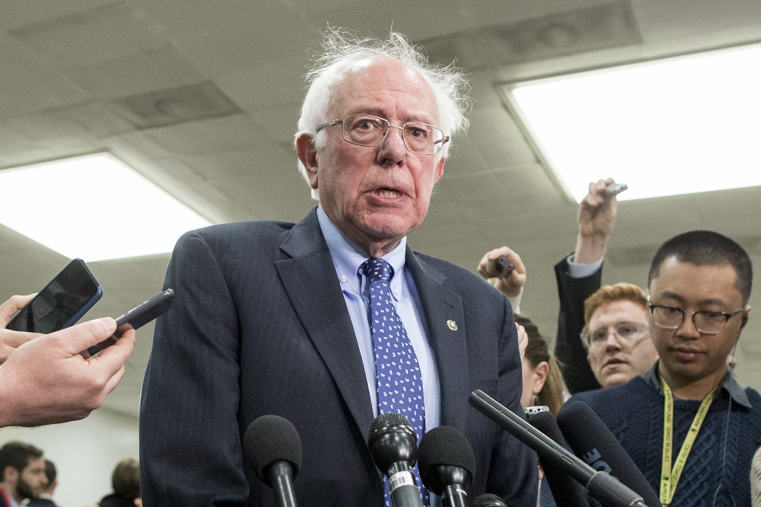 epa07195588 Independent Senator from Vermont Bernie Sanders (C) speaks to members of the news media following a closed briefing for US senators on Saudi Arabia, on Capitol Hill in Washington, DC, USA, ...