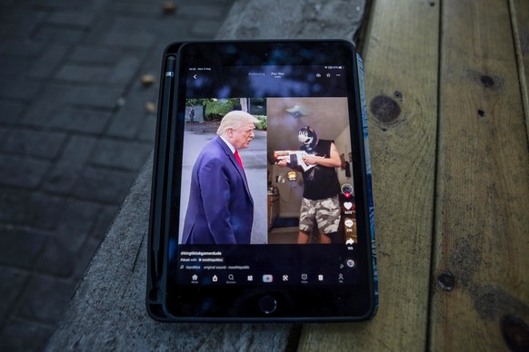 epa08581692 US President Donald Trump is seen on the TikTok app post on a bench in Shanghai, China, 03 August 2020. According to media reports, Microsoft is in talks to buy the US operations of Chines ...