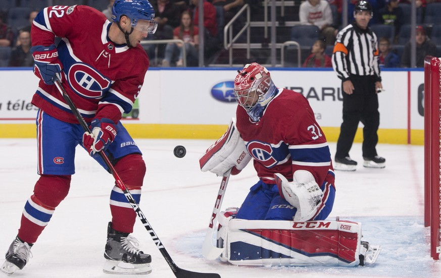 Montreal Canadiens goalie Carey Price, right, makes a save as teammate Mark Streit skates to the net against the Toronto Maple Leafs during the first period of a preseason NHL hockey game, Wednesday,  ...