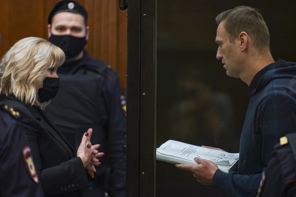 epa08980989 A handout photo made available by Moscow&#039;s Citiy Court Press Service shows Russian opposition leader Alexei Navalny (R) speaks with his lawyer Olga Mikhailova (L) before a hearing in  ...