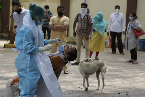 A health worker takes a nasal swab sample of a woman at an urban health centre in Ahmedabad, India, Thursday, July 16, 2020. India&#039;s virus cases surged another 32,695 as of Thursday, taking the n ...