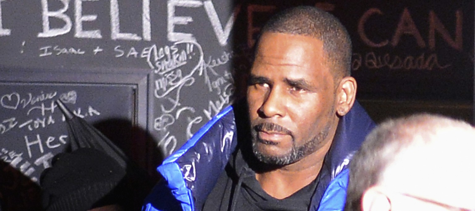 Musician R. Kelly leaves his Chicago studio Friday night, Feb. 22, 2019, on his way to surrender to police. R&amp;B star Kelly was taken into custody after arriving Friday night at a Chicago police pr ...