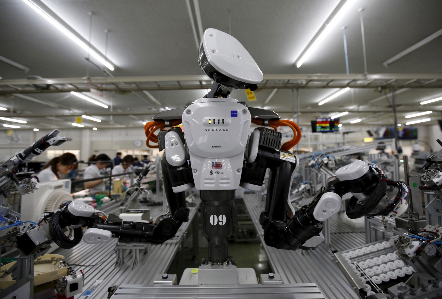 FILE PHOTO - A humanoid robot works side by side with employees in the assembly line at a factory of Glory Ltd., a manufacturer of automatic change dispensers, in Kazo, north of Tokyo, Japan, July 1,  ...
