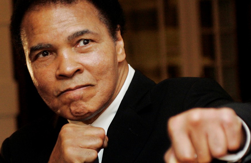 U.S. boxing great Muhammad Ali poses during the Crystal Award ceremony at the World Economic Forum (WEF) in Davos, Switzerland, in this January 28, 2006 file photo. REUTERS/Andreas Meier/File Photo TP ...