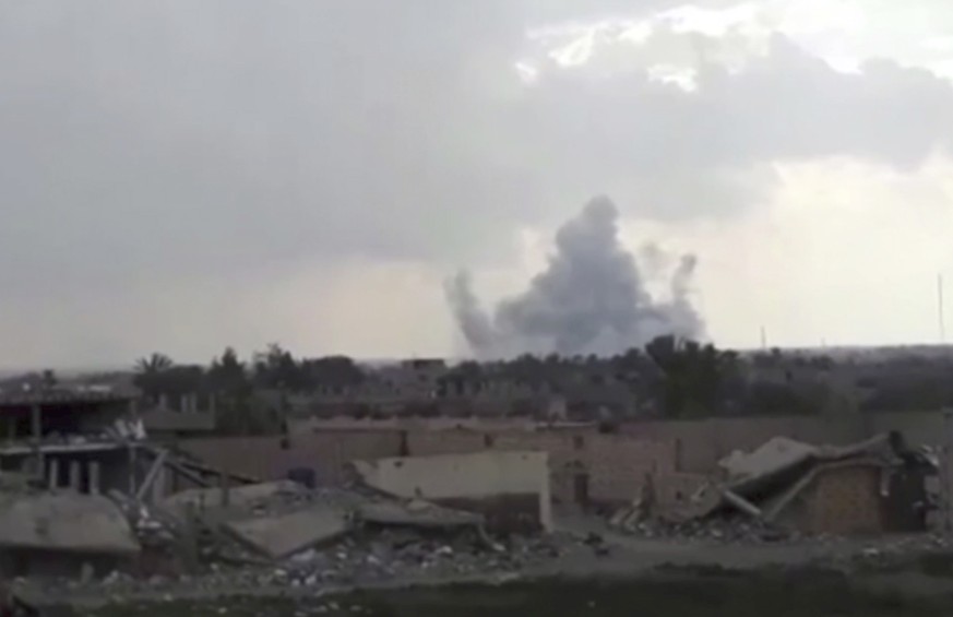 This frame grab from video provided on Tuesday, Feb. 12, 2019, by the Syrian Observatory for Human Rights, an opposition group, that is consistent with independent AP reporting, shows smoke rising fro ...