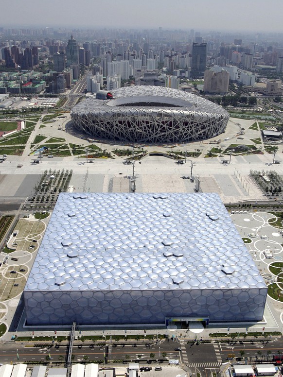 In this aerial photo reviewed by the Chinese military, the National Aquatics Center, known as the Water Cube, foreground, and the National Stadium, also known as the Bird&#039;s Nest, are seen at the  ...