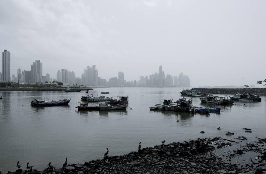 Boats sit docked in the bay as a Sahara dust cloud looms over Panama City, Thursday, June 25, 2020. (AP Photo/Arnulfo Franco)