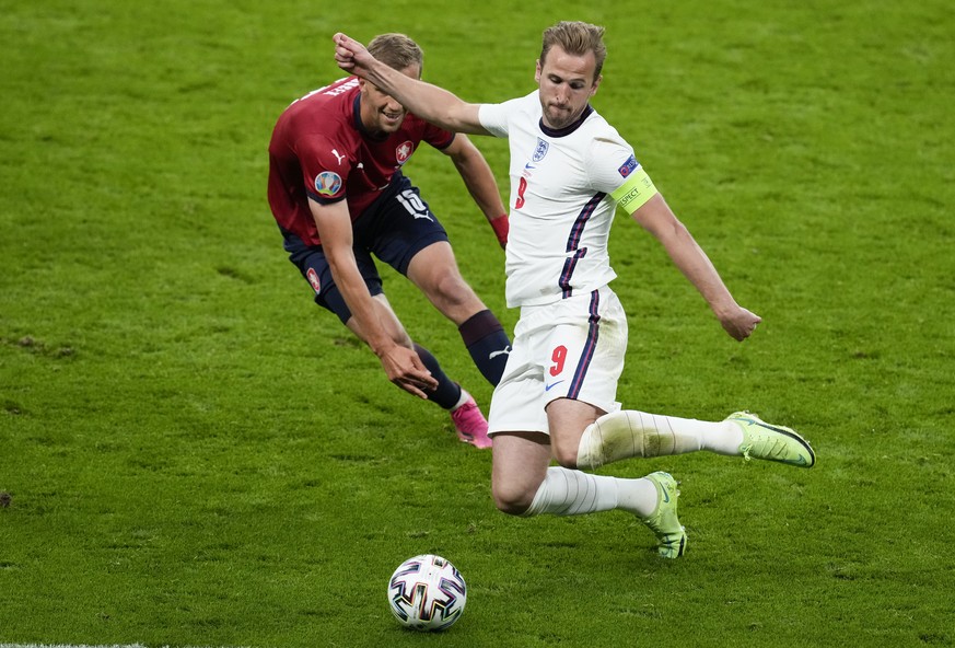 England&#039;s Harry Kane kicks the ball as Czech Republic&#039;s Tomas Soucek watches during the Euro 2020 soccer championship group D match between the Czech Republic and England at Wembley stadium, ...