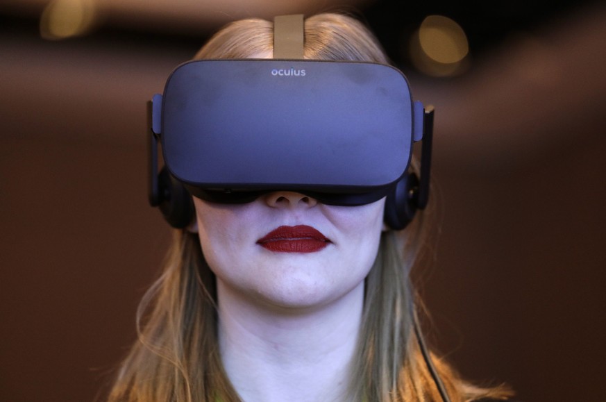 FILE- In this Jan. 4, 2017, photo a woman participates in a virtual realty presentation during an Intel news conference before CES International in Las Vegas. The weeklong event is one of the world’s  ...
