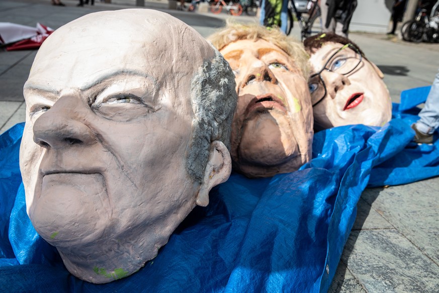 epa07779474 Masks of (L-R) German Minister of Finance Olaf Scholz, German Chancellor Angela Merkel, and Chairwoman of German Christian Democratic Union party (CDU) and German Defence Minister Annegret ...