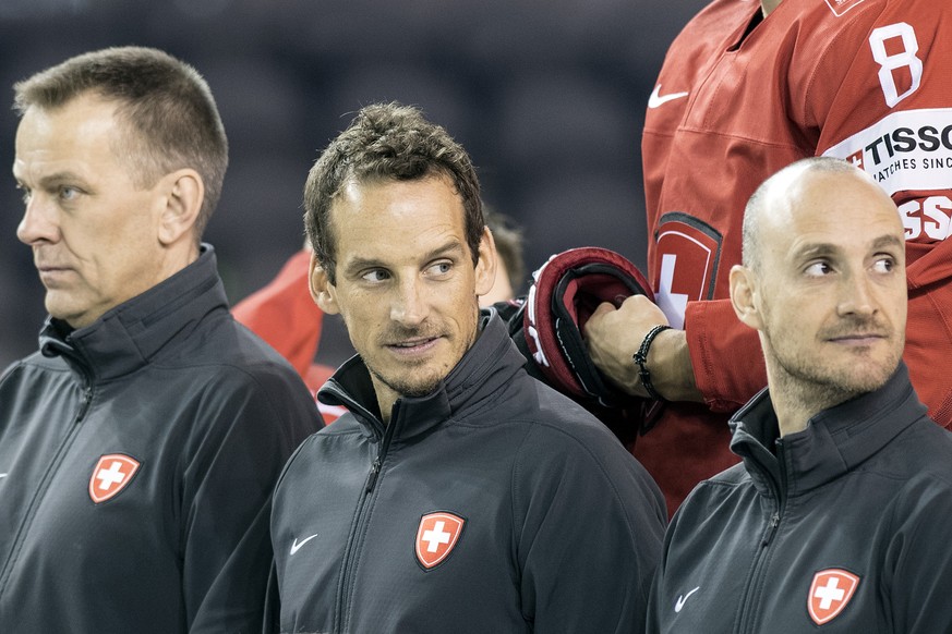 Switzerland&#039;s Tommy Albelin, assistant coach, Patrick Fischer, head coach and Christian Wohlwend, assistant coach, from left, pose during a photo session before a training session during the Ice  ...