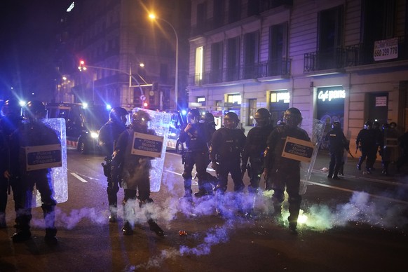 Fireworks explode among riot police during clashes following a protest condemning the arrest of rap singer Pablo Hasél in Barcelona, Spain, Saturday, Feb. 20, 2021. A fifth night of peaceful protests  ...