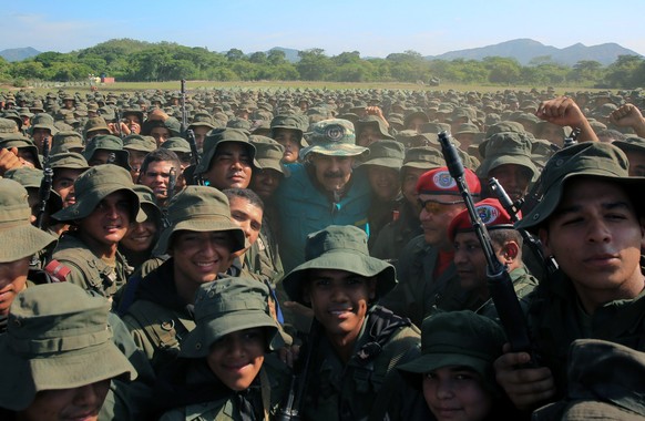 epa07681570 A handout photo made available by Miraflores Press Office shows Venezuelan President Nicolas Maduro (C) as he poses for a picture with members of the military in Cojedes State, Venezuela,  ...