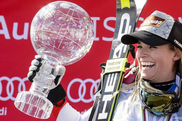 Lara Gut of Switerland celebrates with the women&#039;s Alpine Skiing World Cup Overall trophy during the podium ceremony at the FIS Alpine Ski World Cup Finals, in St. Moritz, Switzerland, Sunday, Ma ...