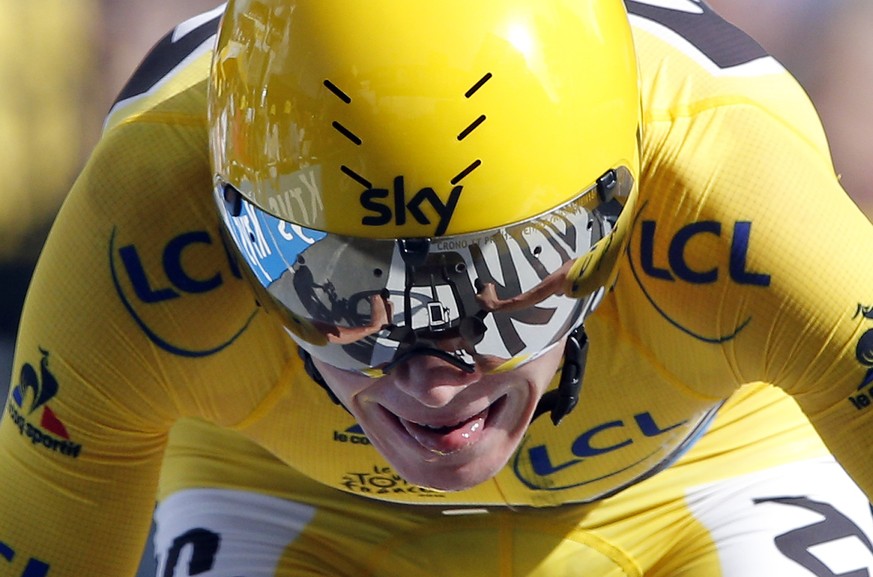 Britain&#039;s Chris Froome, wearing the overall leader&#039;s yellow jersey crosses the finish line to win the eighteenth stage of the Tour de France cycling race, an individual time trial over 17 ki ...