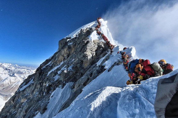 (FILES) In this file handout photo taken on May 22, 2019 and released by climber Nirmal Purja&#039;s Project Possible expedition shows heavy traffic of mountain climbers lining up to stand at the summ ...
