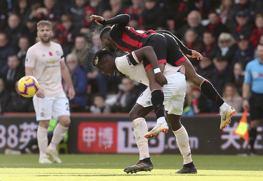 Bournemouth&#039;s Jefferson Lerma, bottom, and Manchester United&#039;s Paul Pogba battle for the ball during the English Premier League soccer match between Bournemouth and Manchester United at The  ...