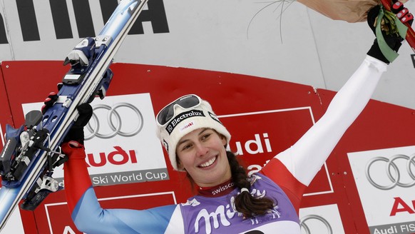 Switzerland&#039;s Dominique Gisin celebrates on the podium after winning an alpine ski, women&#039;s World Cup downhill race, in Cortina D&#039;Ampezzo, Italy, Saturday, Jan. 24, 2009. (AP Photo/Marc ...