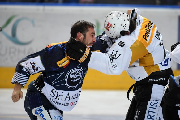 Ambri&#039;s player Matt D&#039;Agostini, left, fights with Lugano’s player Alessandro Chiesa, right, during the regular season game of National League A (NLA) Swiss Championship 2017/18 between HC Am ...