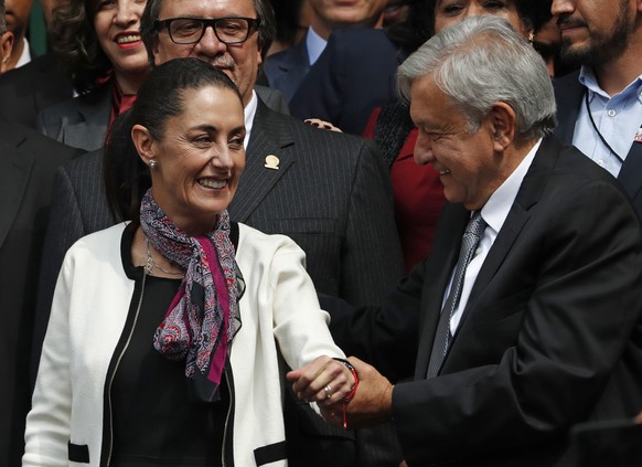 The first elected female mayor of Mexico City Claudia Sheinbaum, left, and President Andres Manuel Lopez Obrador, leave the Senate after she was sworn into office, in Mexico City, Wednesday, Dec. 5, 2 ...
