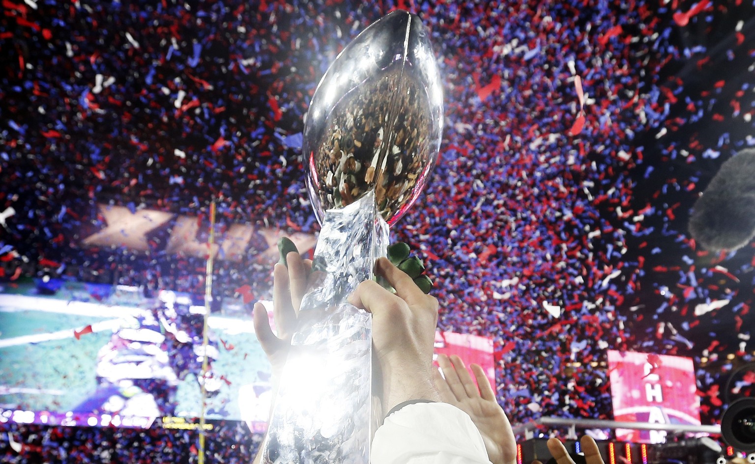 GLENDALE, AZ - FEBRUARY 01: Members of the New England Patriots celebrate with the Vince Lombardi Trophy after defeating the Seattle Seahawks 28-24 in Super Bowl XLIX at University of Phoenix Stadium  ...