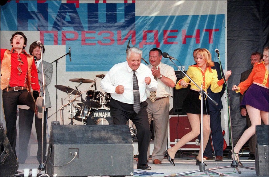 Russian President Boris Yeltsin (c) shown in picture dated 10 June 1996 in Rostov, dances with a musicians during a rock performance as part of his pre-election campaign tour ahead of the 16 June pres ...