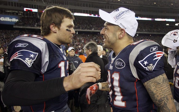 FILE - In this Sunday, Jan. 22, 2012, file photo, New England Patriots quarterback Tom Brady, left, congratulates Aaron Hernandez after their AFC Championship NFL football game against the Baltimore R ...